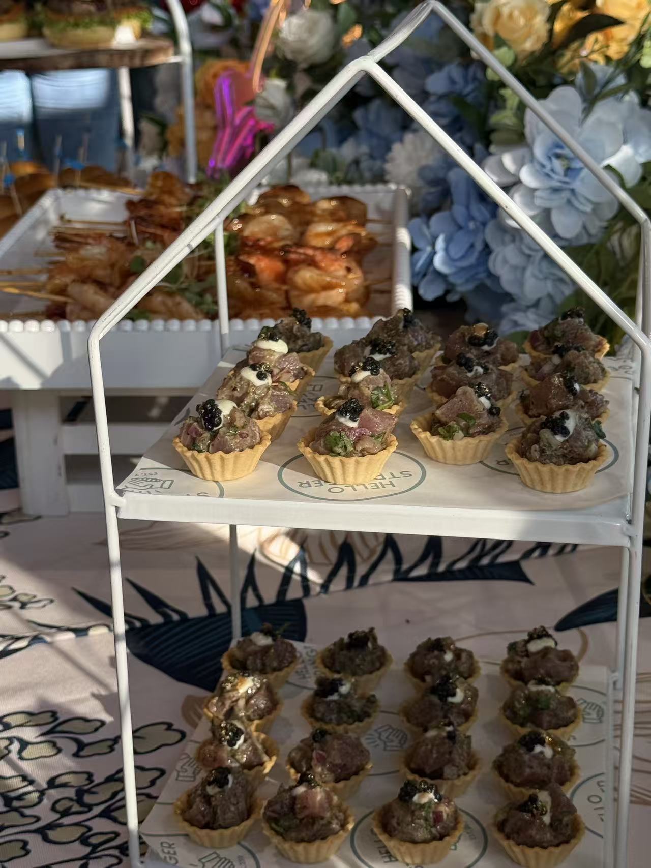 Beef tartare tartlets with caviar on a tiered stand