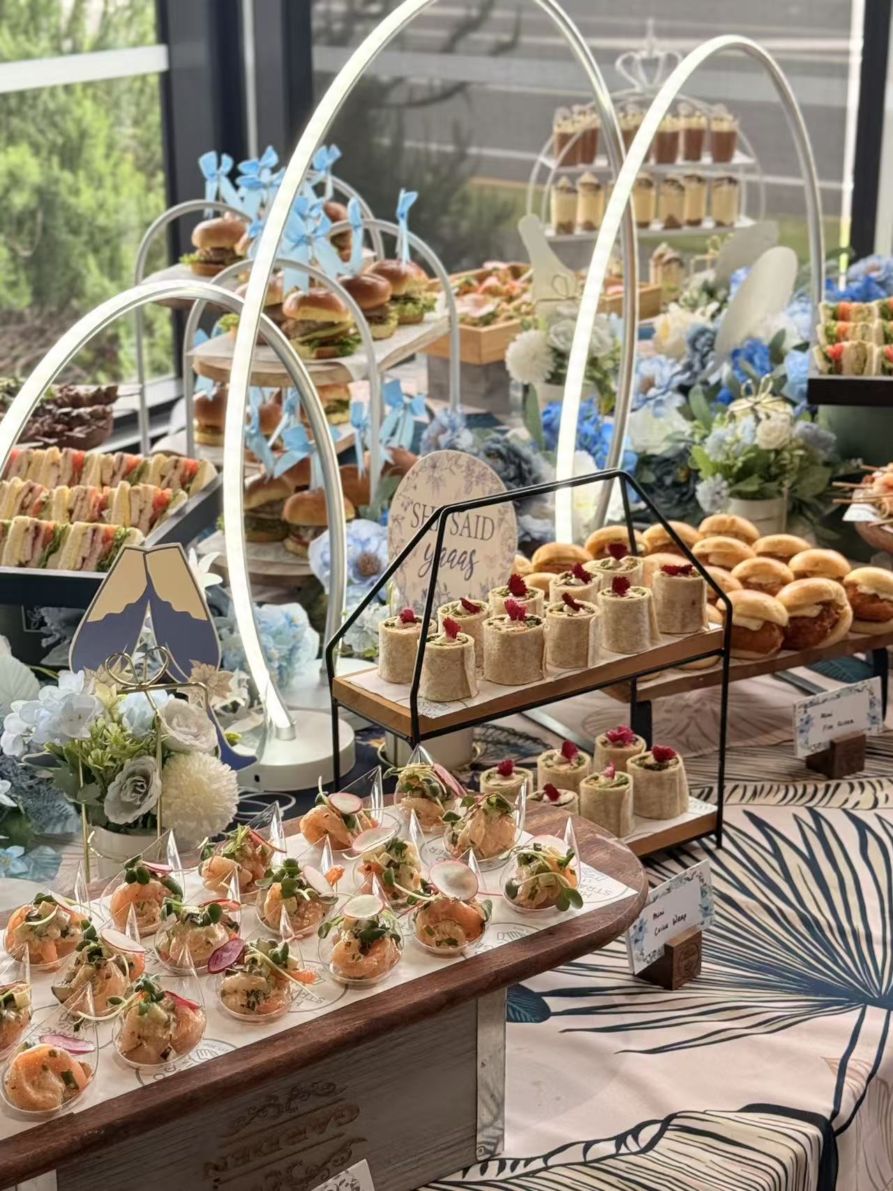 Event spread with sliders, wraps and prawn cocktail cups